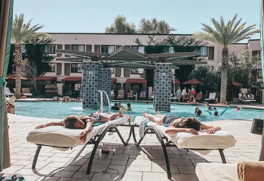 kids enjoying the lounge chairs at the pool